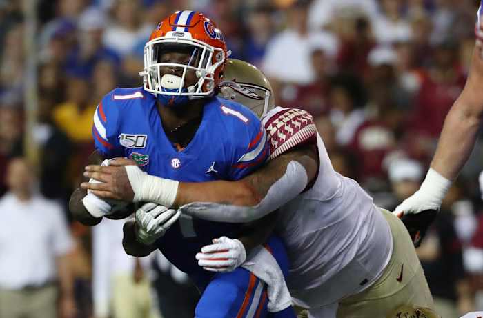Nov 30, 2019; Gainesville, FL, USA; Florida State Seminoles defensive tackle Cory Durden (16) tackles Florida Gators wide receiver Kadarius Toney (1) during the first quarter at Ben Hill Griffin Stadium.