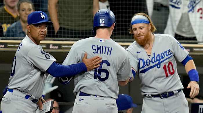 Los Angeles Dodgers catcher Will Smith (16) is congratulated by manager Dave Roberts (left) and third baseman Justin Turner (10) after his home run in the seventh inning at Petco Park.