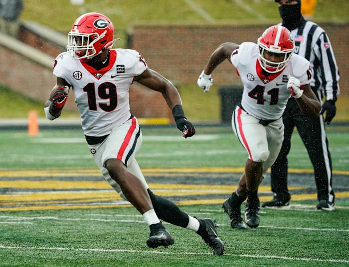 Dec 12, 2020; Columbia, Missouri, USA; Georgia Bulldogs linebacker Adam Anderson (19) and linebacker Channing Tindall (41) defend against the Missouri Tigers during the second half at Faurot Field at Memorial Stadium.