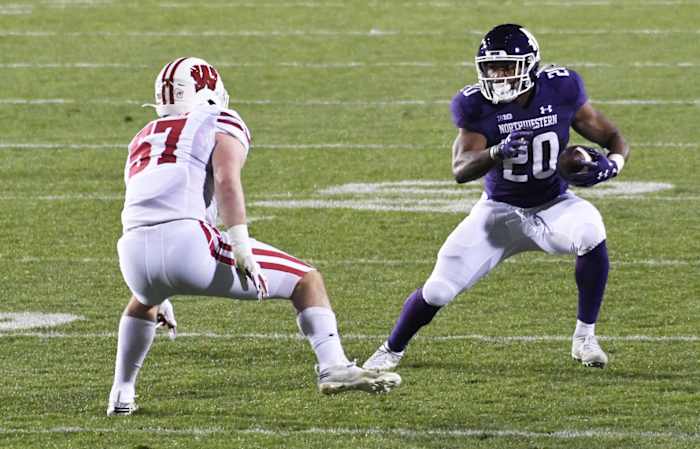 Nov 21, 2020; Evanston, Illinois, USA;Wisconsin Badgers linebacker Jack Sanborn (57) defends Northwestern Wildcats running back Cam Porter (20) during the second half at Ryan Field.