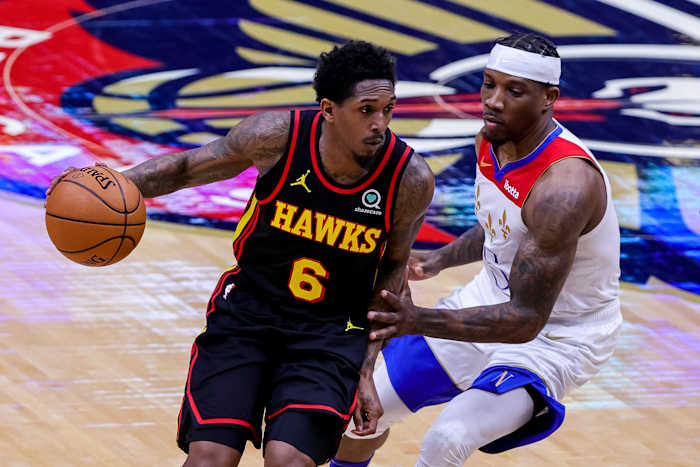 Atlanta Hawks guard Lou Williams dribbles around New Orleans Pelicans guard Eric Bledsoe