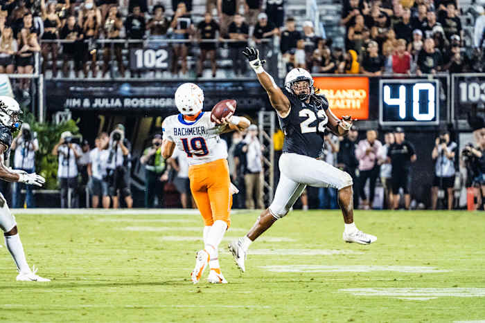 Kalia Davis Rushing Hank Bachmeier of Boise State