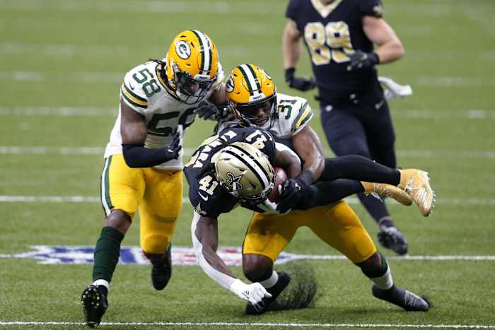 New Orleans RB Alvin Kamara is brought down by Green Bay S Adrian Amos (31). Credit: greenbaypressgazette.com