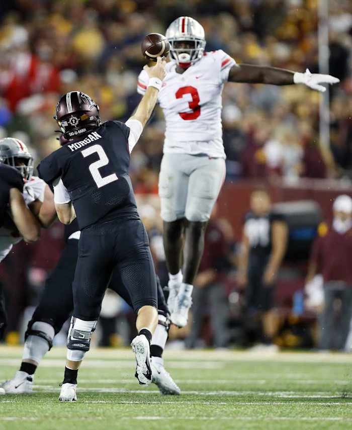 Linebacker Teradja Mitchell (3) tries to block the throw of Minnesota Golden Gophers quarterback Tanner Morgan (2).