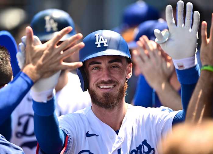 Los Angeles Dodgers outfielder Cody Bellinger celebrates with his teammates in the dugout. (2022)