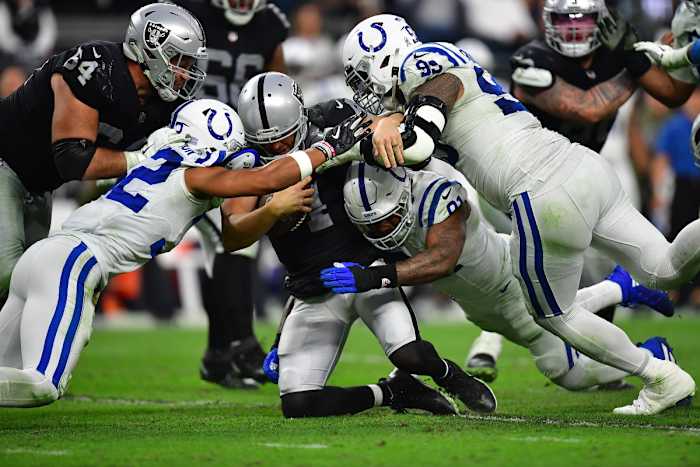 Nov 13, 2022; Paradise, Nevada, USA; Las Vegas Raiders quarterback Derek Carr (4) is brought down by Indianapolis Colts defensive tackle DeForest Buckner (99) defensive end Yannick Ngakoue (91) and safety Julian Blackmon (32) and during the second half at Allegiant Stadium.