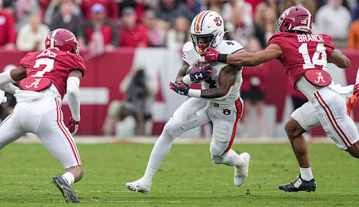 Tank Bigsby (4) tries to break through the tackle during the game between Auburn and Alabama at Bryant-Denny Stadium. Austin Perryman/AU Athletics