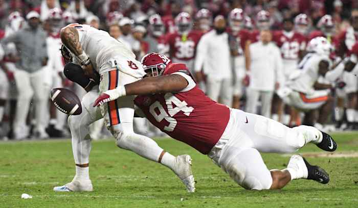 Auburn Tigers quarterback Robby Ashford (9) fumbles as he is hit by Alabama Crimson Tide defensive lineman DJ Dale (94) at Bryant-Denny Stadium. Alabama won 49-27.