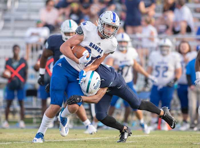 DII tight end Kyle Morlock running the football to avoid a tackle.
