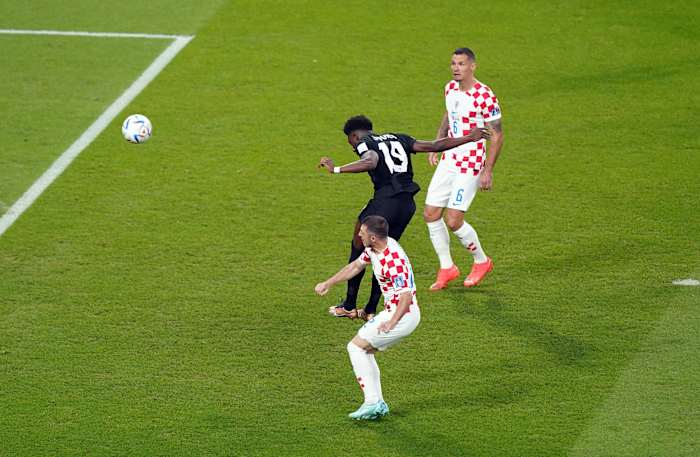 Alphonso Davies pictured heading the ball to score Canada's first ever goal at a FIFA Men's World Cup, against Croatia at Qatar 2022