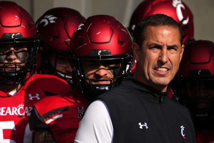 Cincinnati head coach Luke Fickell standing with his team before running onto the field.