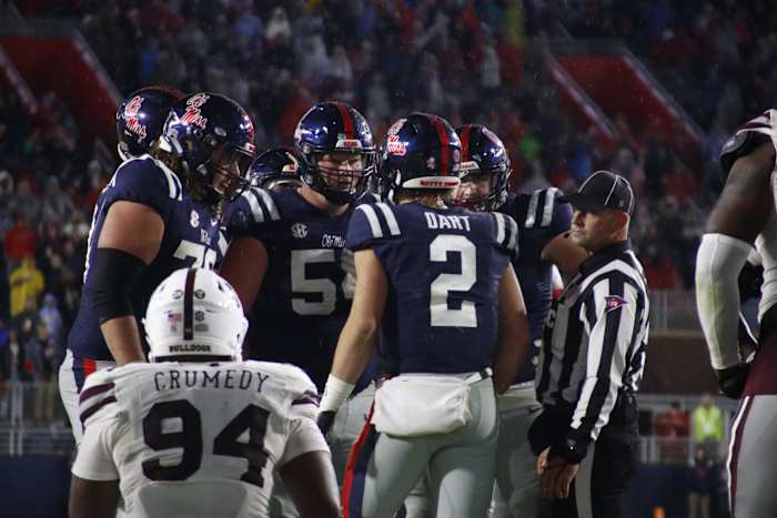 Jaxson Dart Ole Miss huddle navy