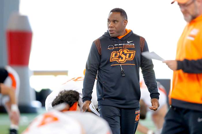 OSU defensive coordinator Derek Mason watches the team stretch before practice on April 11 in Stillwater