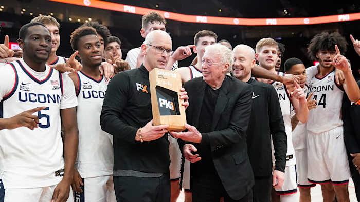 Dan Hurley and UConn receive the Phil Knight Invitational trophy