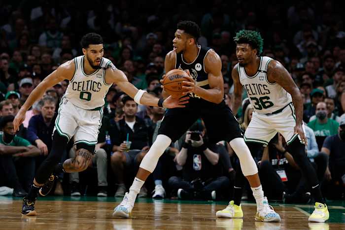 Boston Celtics forward Jayson Tatum (0) tries to steal the ball from Milwaukee Bucks forward Giannis Antetokounmpo