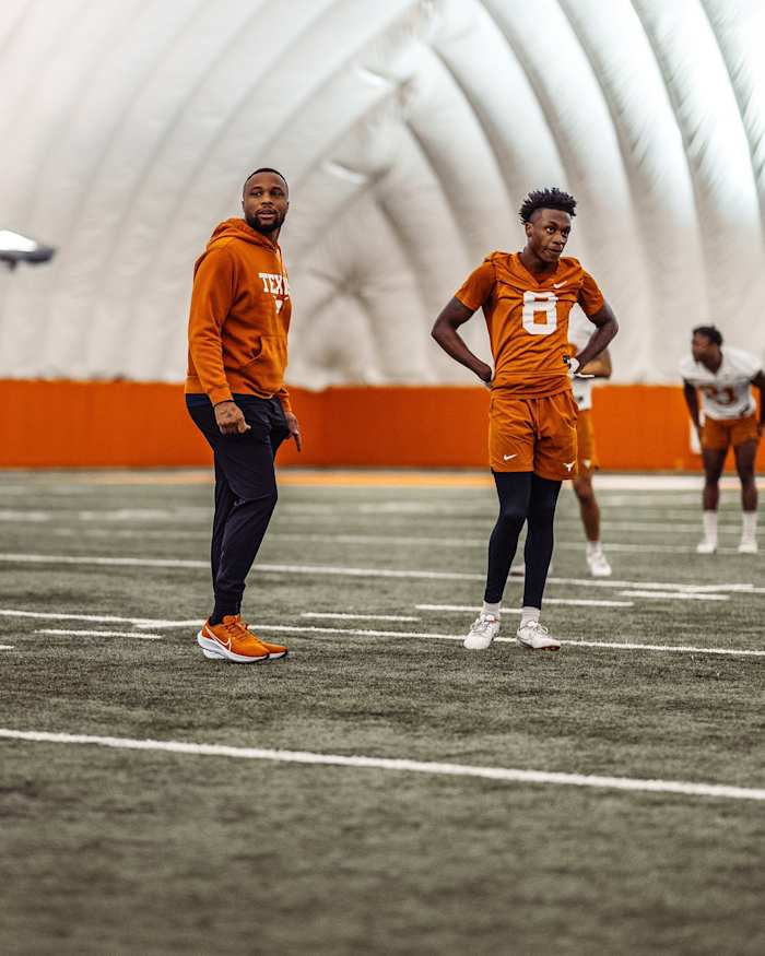 Texas wide receivers coach Brennan Marion with Xavier Worthy.