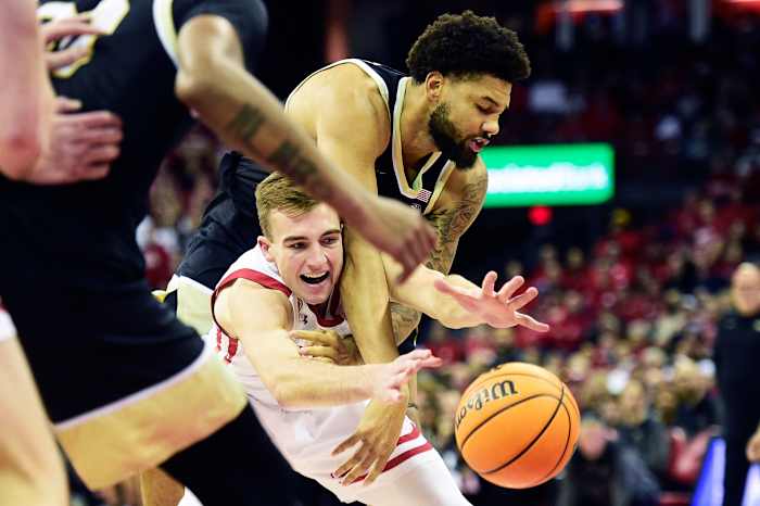 Davion Bradford and Tyler Wahl battle for a loose ball