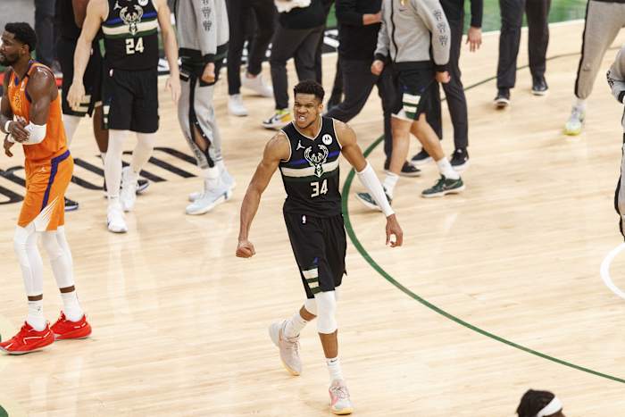 Milwaukee Bucks forward Giannis Antetokounmpo (34) begins to celebrate