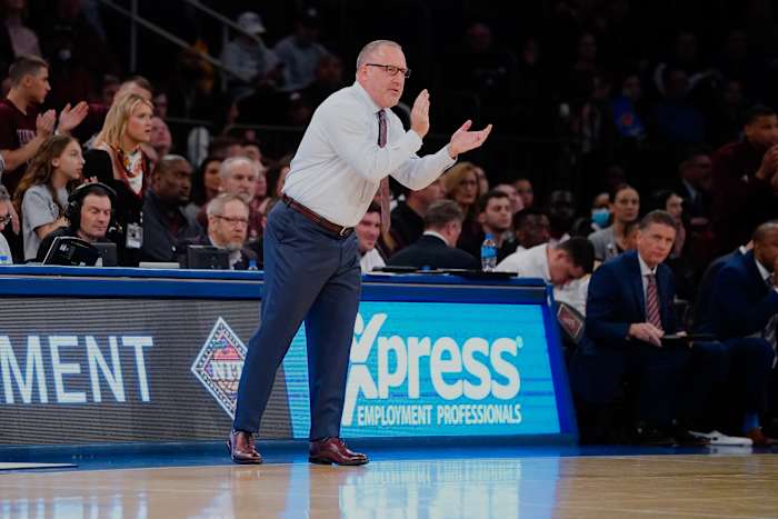 Texas A&M Aggies coach Buzz Williams claps at his team from the sidelines.