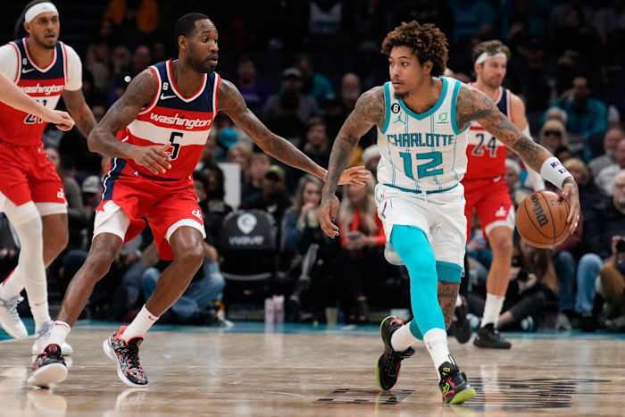 Charlotte Hornets guard Kelly Oubre Jr. (12) handles the ball guarded by Washington Wizards forward Will Barton (5) during the second half at Spectrum Center.