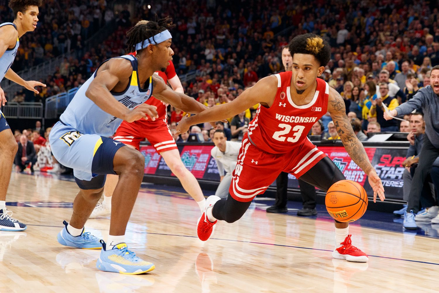 Wisconsin guard Chucky Hepburn dribbling the basketball against Marquette.