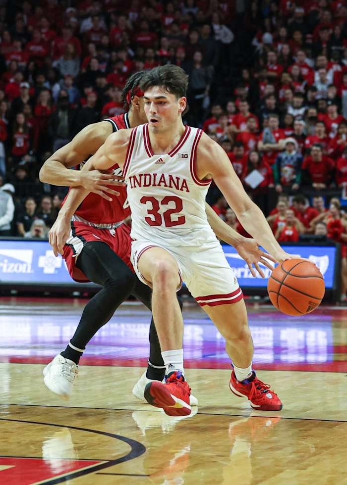 Indiana Hoosiers guard Trey Galloway (32) dribbles as Rutgers Scarlet Knights guard Derek Simpson (0) defends during the first half at Jersey Mike's Arena.