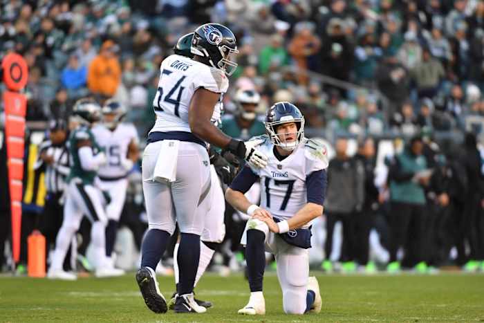 Tennessee Titans quarterback Ryan Tannehill (17) is helped up by guard Nate Davis (64) against the Philadelphia Eagles during the fourth quarter at Lincoln Financial Field.