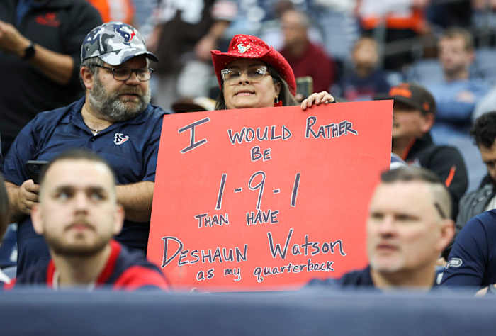 A Texans fan holds up an anti-Deshaun Watson sign