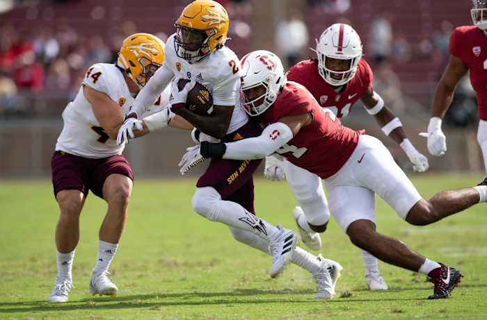 Stanford, California, USA; Arizona State Sun Devils wide receiver Elijhah Badger (2) is brought down by Stanford Cardinal linebacker Jacob Mangum-Farrar (14) after a pass reception during the first quarter at Stanford Stadium.