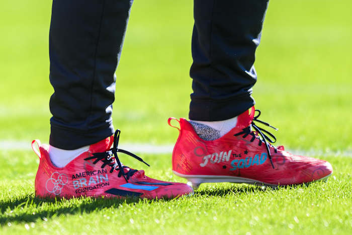 View of red and black cleats.