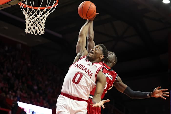 Indiana Hoosiers guard Xavier Johnson (0) drives to the basket drives to the basket as Rutgers Scarlet Knights forward Mawot Mag (3) defends during the first half at Jersey Mike's Arena.