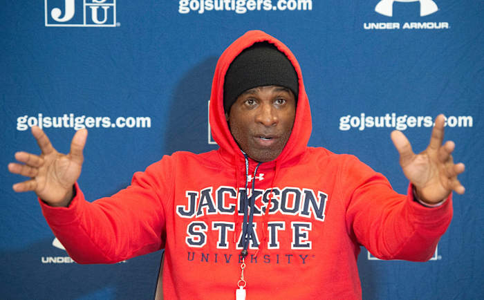 Deion Sanders speaks at a press conference.