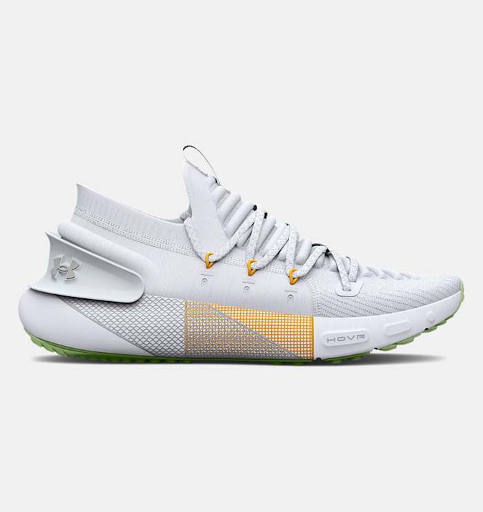 Side view of white and yellow Under Armour running shoe.