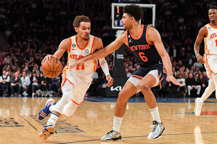 Hawks guard Trae Young dribbles past Knicks guard Quentin Grimes.