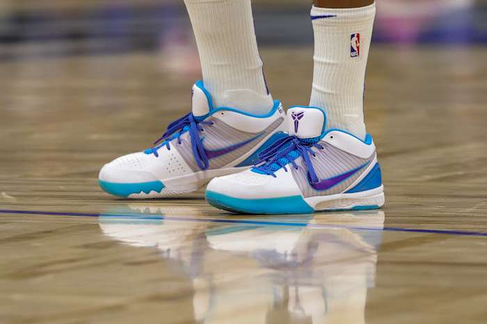 A view of white, teal, and purple Nike Kobe shoes.