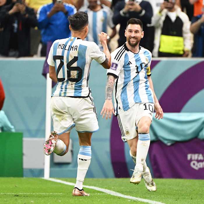 Lionel Messi pictured (right) celebrating with Nahuel Molina after an Argentina goal against Holland at the 2022 World Cup