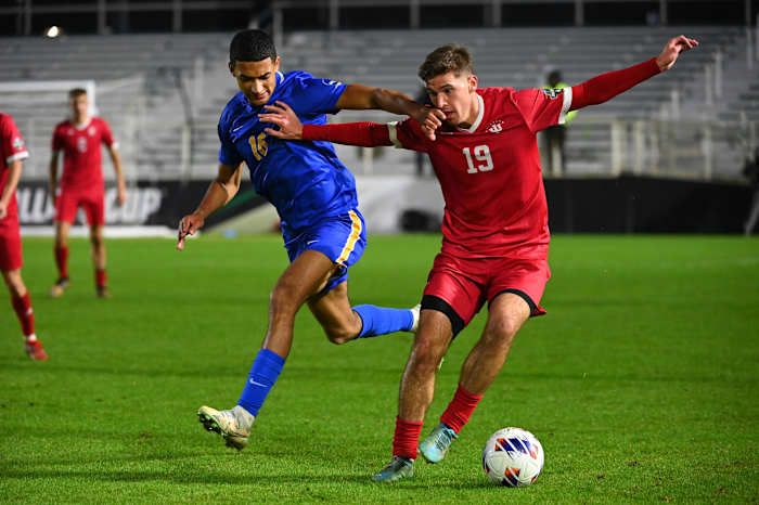 Dec 9, 2022; Cary, NC, USA; Indiana defender Brett Bebej (19) with the ball as Pittsburgh forward Bertin Jacquesson (10) defends in the second half at WakeMed Soccer Park. Mandatory Credit: Bob Donnan-USA TODAY Sports