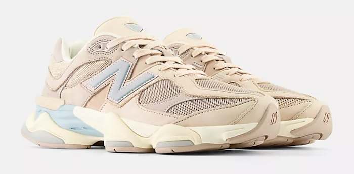 View of tan New Balance shoes.