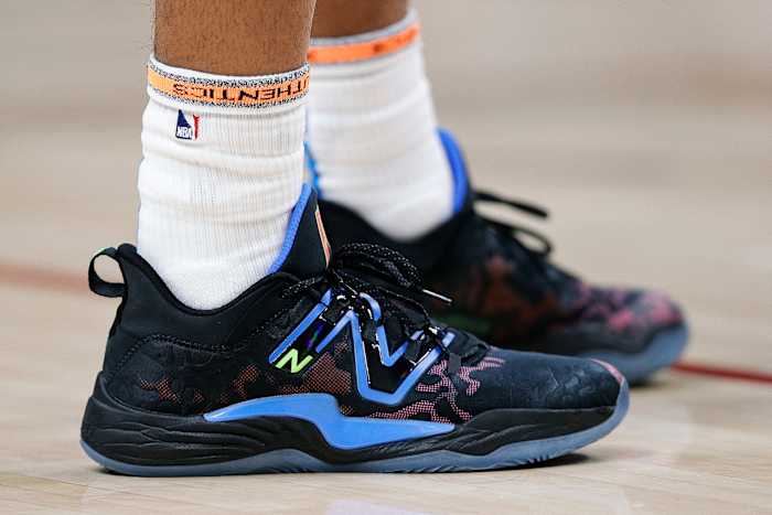 View of black and blue New Balance shoes.