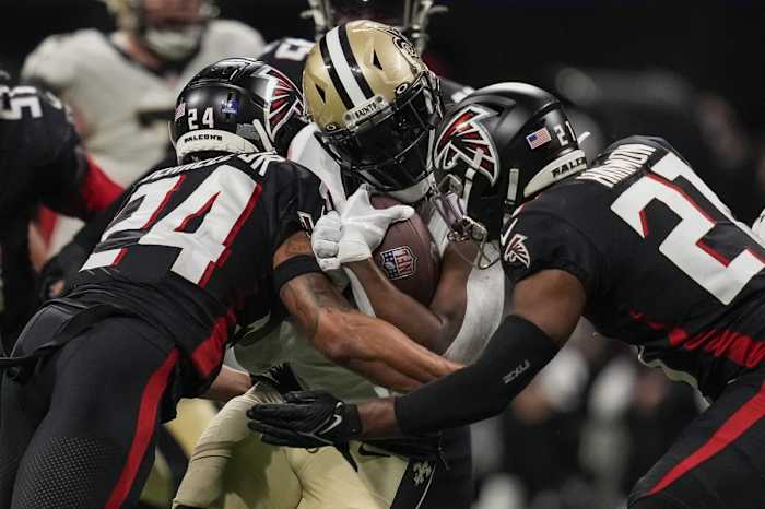 Jan 9, 2022; New Orleans Saints running back Alvin Kamara (41) is tackled by Atlanta Falcons cornerback A.J. Terrell (24) and safety Richie Grant (27). Mandatory Credit: Dale Zanine-USA TODAY