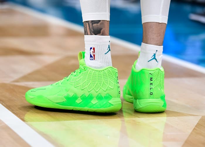 A detailed view of green Puma shoes.