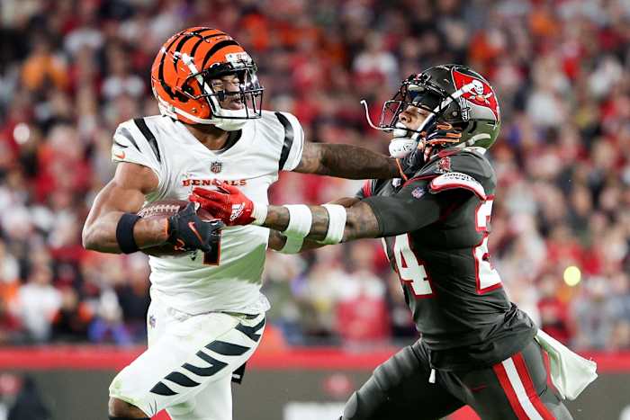 Dec 18, 2022; Tampa, Florida, USA; Cincinnati Bengals wide receiver Ja'Marr Chase (1) holds off Tampa Bay Buccaneers cornerback Carlton Davis III (24) in the third quarter at Raymond James Stadium. Mandatory Credit: Nathan Ray Seebeck-USA TODAY Sports