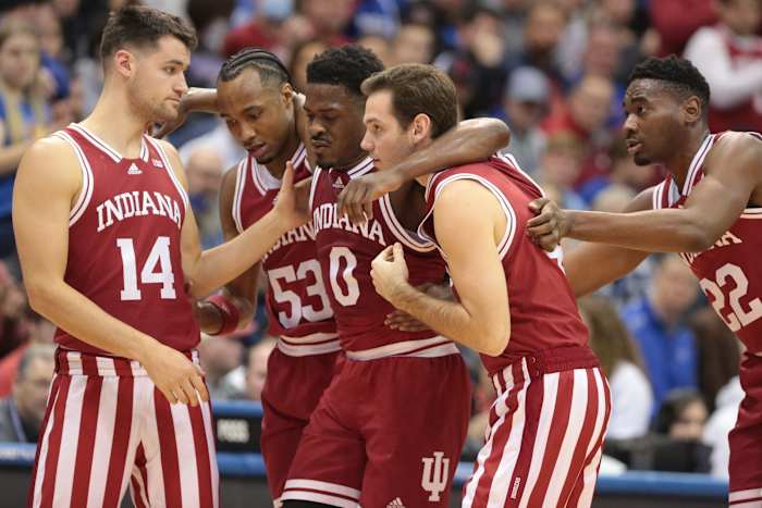Indiana super-senior Xavier Johnson (0) is helped off the court after an injury during the first half of Saturday's game inside Allen Fieldhouse.