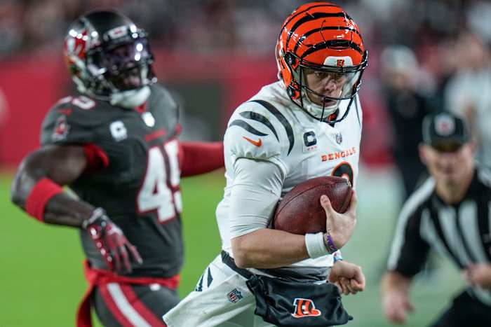 Cincinnati Bengals quarterback Joe Burrow (9) runs past Tampa Bay Buccaneers linebacker Devin White (45) during the second half of an NFL football game, Sunday, Dec. 18, 2022, in Tampa, Fla.