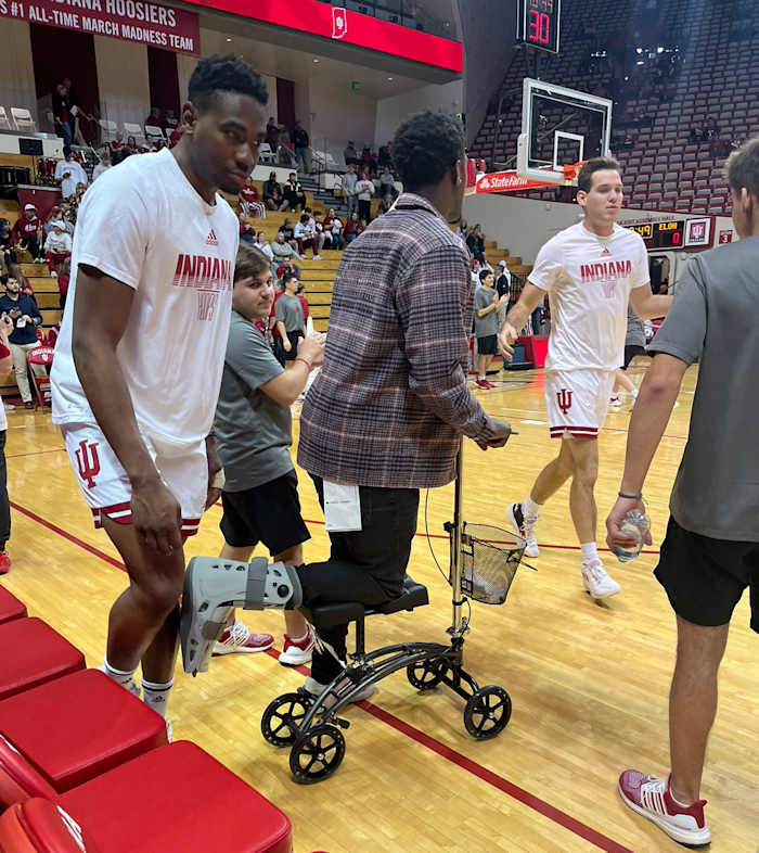 Indiana point guard Xavier Johnson with a walking boot and scooter during pregame warmups on Tuesday against Elon at Simon Skjodt Assembly Hall.
