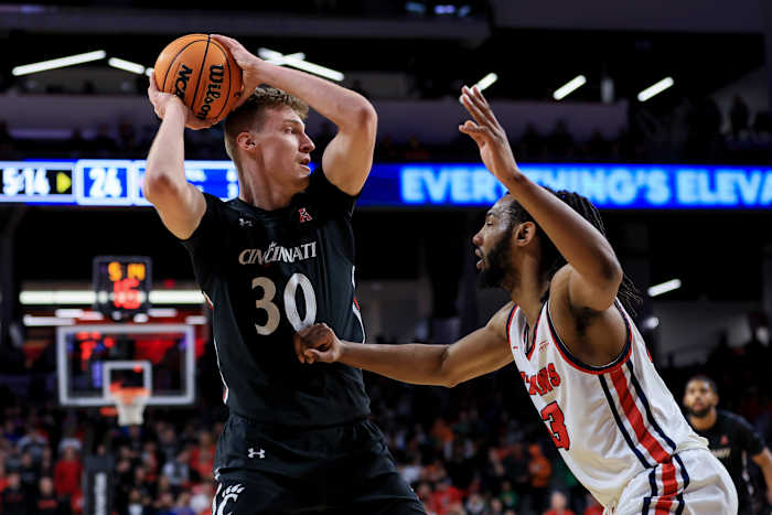 Dec 21, 2022; Cincinnati, Ohio, USA; Cincinnati Bearcats forward Viktor Lakhin (30) controls the ball against Detroit Mercy Titans forward Damezi Anderson (23) in the first half at Fifth Third Arena. Mandatory Credit: Aaron Doster-USA TODAY Sports