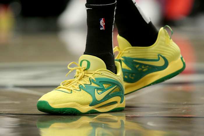 View of yellow and green Nike KD shoes.