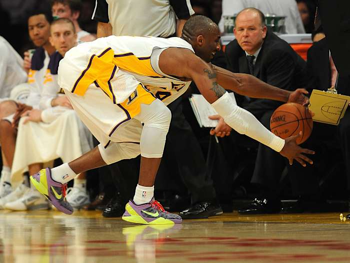 Kobe Bryant reaches for a basketball.