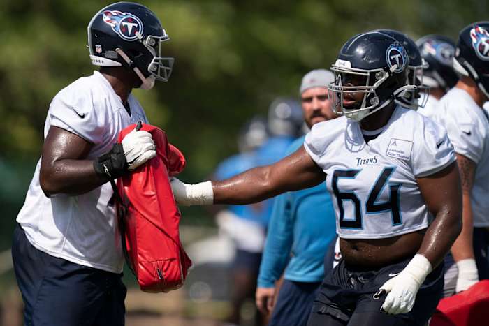 Tennessee Titans guard Nate Davis (64) runs through drills with offensive lineman Nicholas Petit-Frere (78) during practice at Saint Thomas Sports Park Wednesday, June 15, 2022, in Nashville, Tenn.