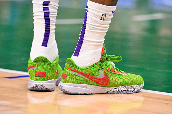 View of green and red Nike LeBron shoes.